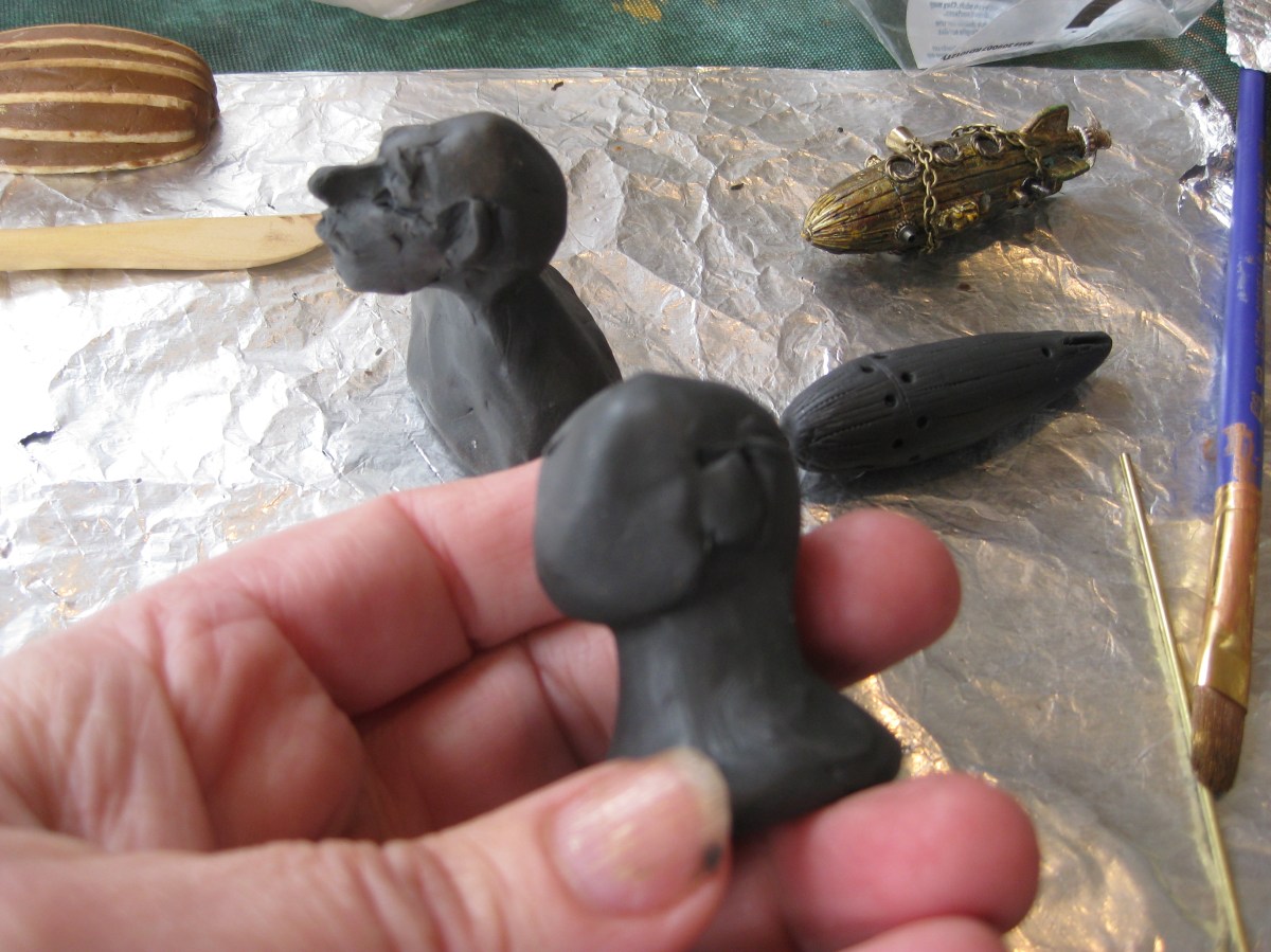 Sculpting heads for snow globes, Camryn Forrest Designs, Denver Colorado